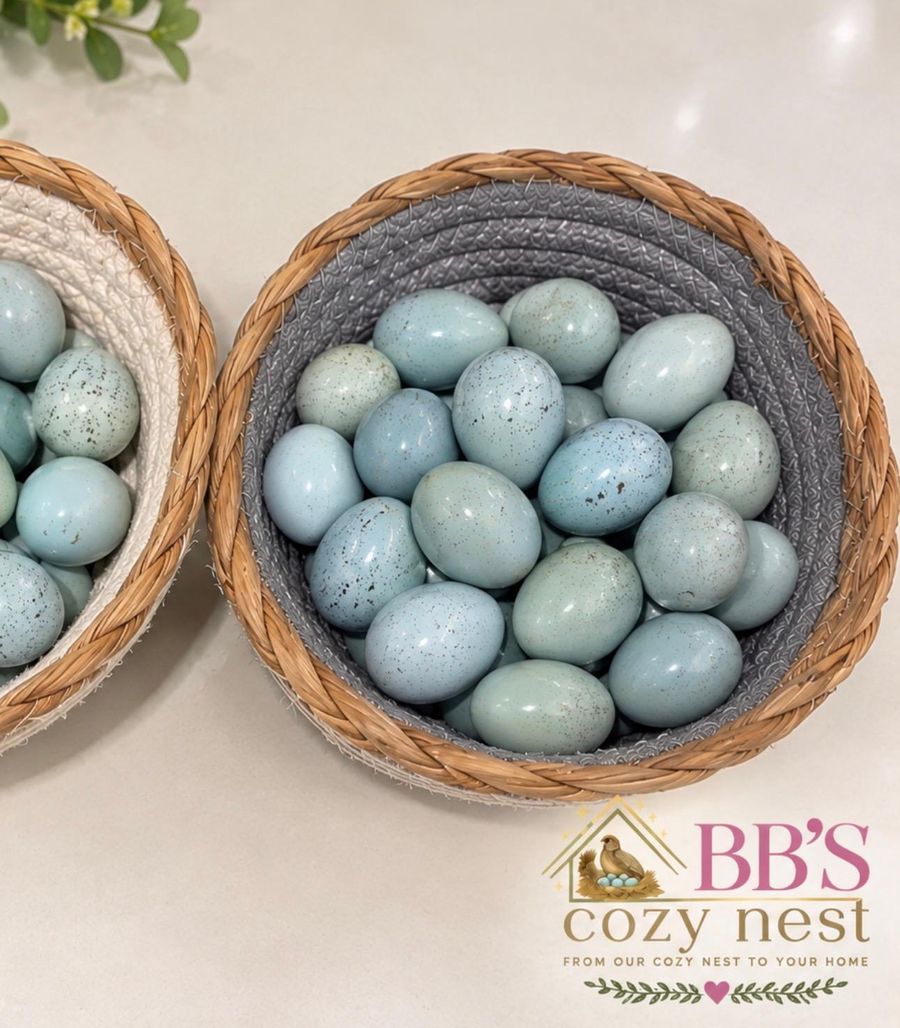 Two woven baskets filled with speckled blue Celadon quail eggs